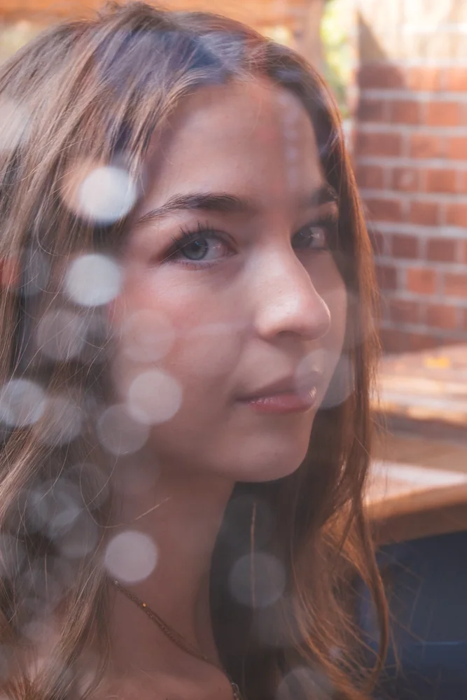 Portrait of a woman seen through reflective glass